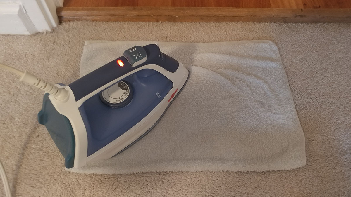 Step 3: Set iron to medium heat and apply it to the towel, moving the iron over the stain for about 15 seconds. Using high heat may burn the carpet! 